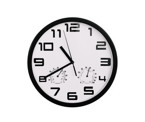 simple classic black and white round wall clock isolated on white. Clock with arabic numerals on wall shows 10:40 , 22:45