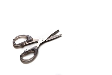 Grey scissor with black handle on white isolated background with copy space 