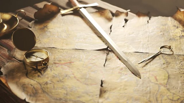 Old, worn, handmade treasure map on a cartoon tavern table. Sword and compass.4K