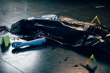 covered corpse with glasses on floor at crime scene - obrazy, fototapety, plakaty