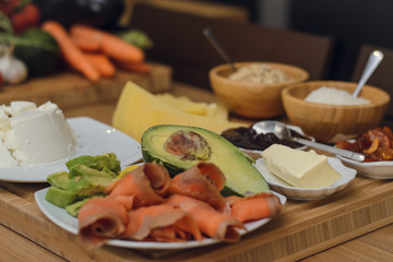 Breakfast of avocado, red fish, butter, jam, porridge. Delicious and healthy breakfast. Vegetarian lunch