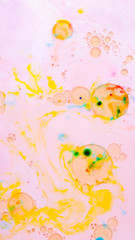 Fluid art. Multicolored background with oil on liquid. Abstract golden pink background on liquid....