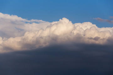 Fototapeta na wymiar Epic dramatic cumulus fluffy white clouds in sunlight against blue sky background, heaven texture
