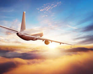 Passengers commercial airplane flying above clouds