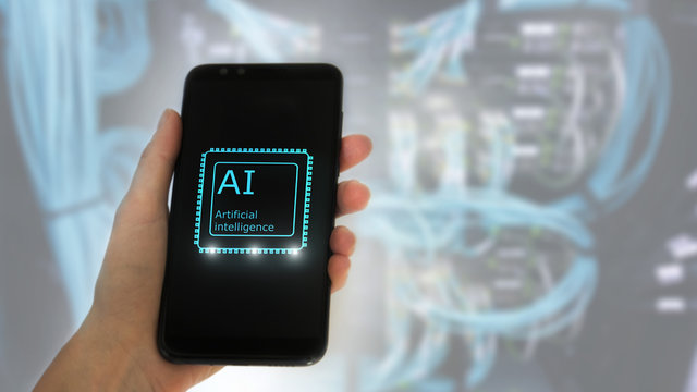 Female hand holds the phone, on the screen the inscription: artificial intelligence. icon hologram 3D on server room background. - Powered by Adobe