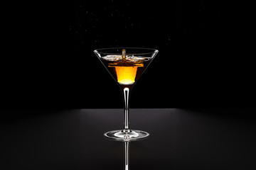 Cocktail yellow-red in baikal for martini with a beautiful splash of drops.