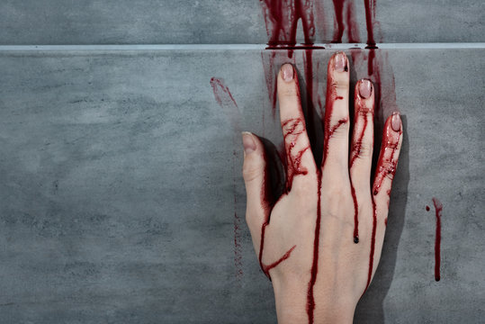 Bleeding Hand And Blood Print On Grey Wall