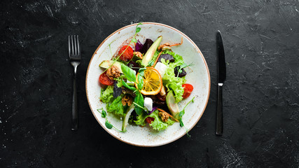 Salad with feta cheese, walnuts and cherry tomatoes. In the plate. Rustic style. Top view. Free space for your text.