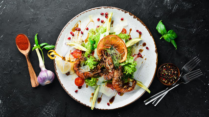 Salad with shrimp and avocado. In the plate. Rustic style. Top view. Free space for your text.
