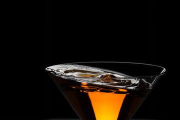 Cocktail yellow-red in baikal for martini with a beautiful splash of droplets close-up       .