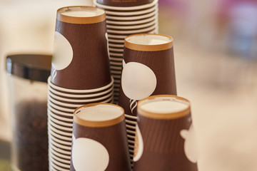 Disposable cardboard cups for coffee. Coffee machine