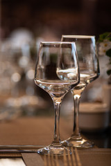 a pair of wine glasses at a banquet table