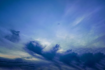 Obraz premium The sky with dark clouds illuminated by the setting sun