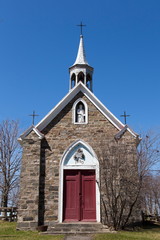 Facade view of historical 1890 fieldstone procession chapel dedicated to Saint-Zacharie, St-Jean-Port-Joli, Quebec, Canada