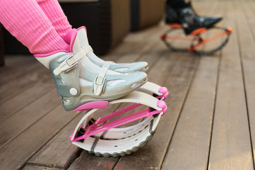 pink kangoo jumping boots at womans legs. fitness workout