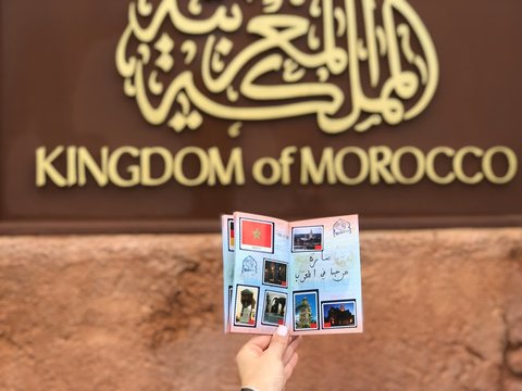 person holding white brochure