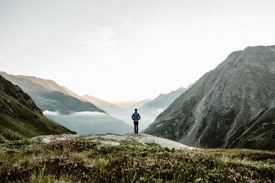 Person Standing On Mountain During Daytime