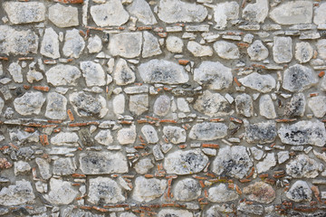 Old rough Stone wall. Ancient masonry.