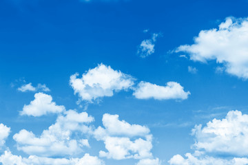 Naklejka na ściany i meble Blurred background. Blue sky and white fluffy clouds.