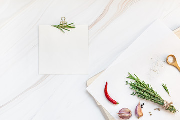 Blank notepad pages with greens herbs and spices