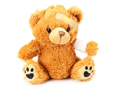 toy teddy bear with bandage isolated on white background