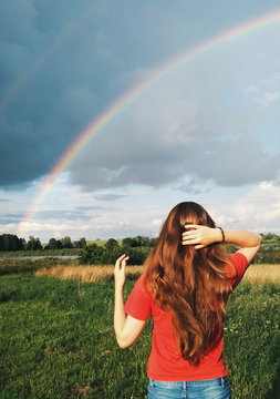 woman looking at rainbow