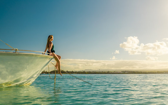 woman sitting on white boat