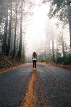 woman standing in the middle of road