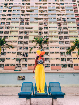 woman standing on gang chair outdoor