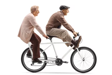 Tuinposter Senior man and woman riding a tandem bicycle with legs up © Ljupco Smokovski