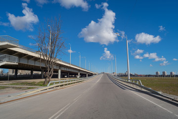 Fototapeta premium Open space with road signs and road markings, road intersections, pedestrian crossings, sunny day, blue sky, city landscape background