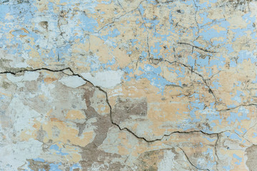 background of a shabby old wall painted in yellow and blue