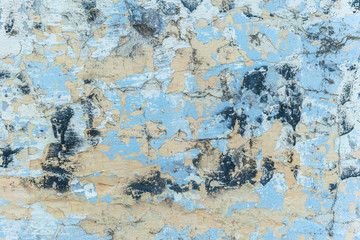 background of a shabby old wall painted in yellow and blue
