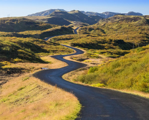zigzagging road by hills