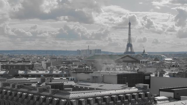 Aerial shot. Paris from above. concept of pollution ecology and environment. Smoke and Roofs of the capital of France in gray. In the distance you can see the Eiffel Tower. Slow Motion.