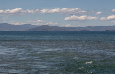 The beauty of Ohrid Lake. Gentle cloud landscape with mountain hills on the horizon.
