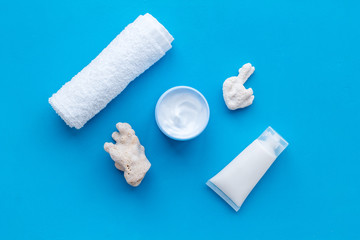 cosmetics with Dead Sea minerals and shells on blue table background top view