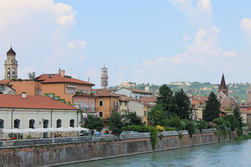 Obraz premium Verona old town in Italy with historical architecture and the river on a clear summer day
