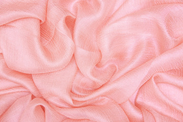 Folds of light pink silk fabric