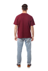 Young man in casual clothes posing on white background
