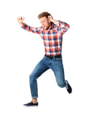 Full length portrait of happy handsome man jumping on white background