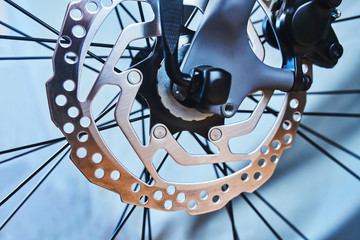 Sport bike front wheel with hydraulic disc on the grey background
