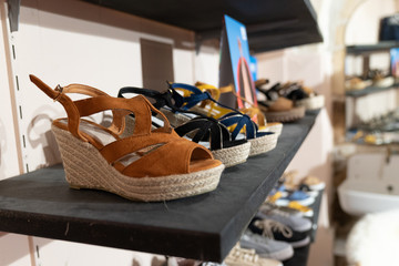 summer shoes on shelf in fashion store