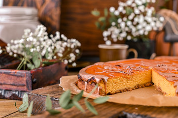 Obraz na płótnie Canvas Cheesecake with chocolate and carrot puree. Vintage photo on wooden background.