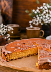 Cheesecake with chocolate and carrot puree. Vintage photo on wooden background.