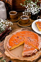 Cheesecake with chocolate and carrot puree. Vintage photo on wooden background.
