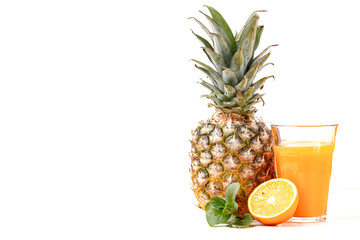 Orange, pineapple and a glass of orange juice on a white background