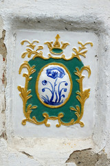 Vintage tiles on the white monastic wall. Uglich.