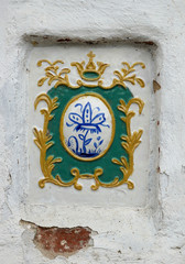 Vintage tiles on the white monastic wall. Uglich.