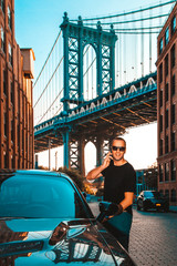 Businessman talking on his cell phone with Manhattan Bridge in background